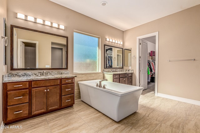 bathroom with vanity and a bathing tub