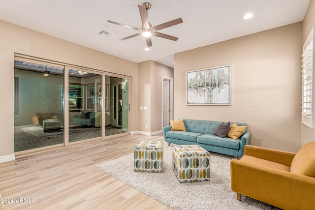 living room with hardwood / wood-style floors and ceiling fan