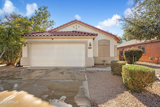 mediterranean / spanish house with a garage