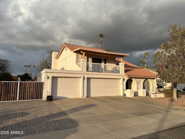 mediterranean / spanish home with a garage and a balcony