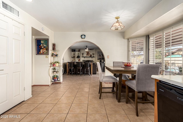 tiled dining space with ceiling fan