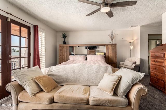 bedroom featuring ceiling fan, carpet, and a textured ceiling