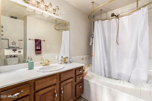 bathroom featuring vanity and shower / bathtub combination with curtain