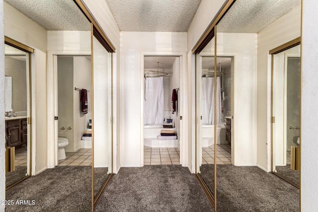 corridor featuring carpet floors and a textured ceiling