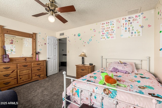 carpeted bedroom with ceiling fan and a textured ceiling