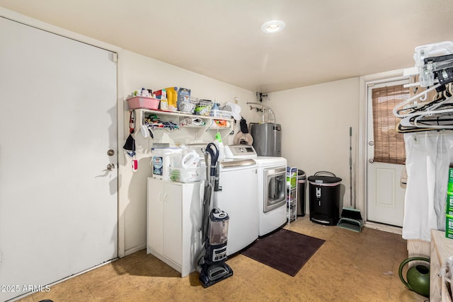 laundry area featuring electric water heater and washing machine and dryer