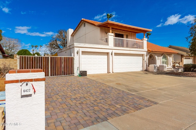 view of front of house with a garage and a balcony