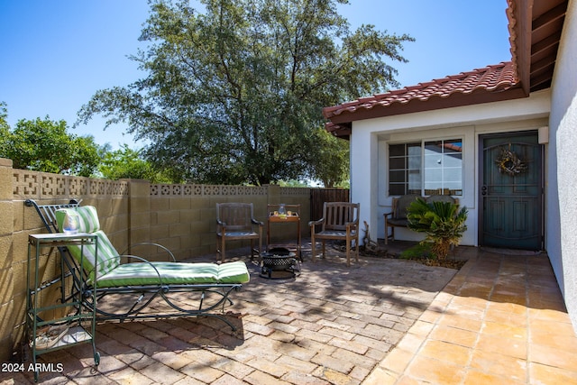 view of patio / terrace with an outdoor fire pit