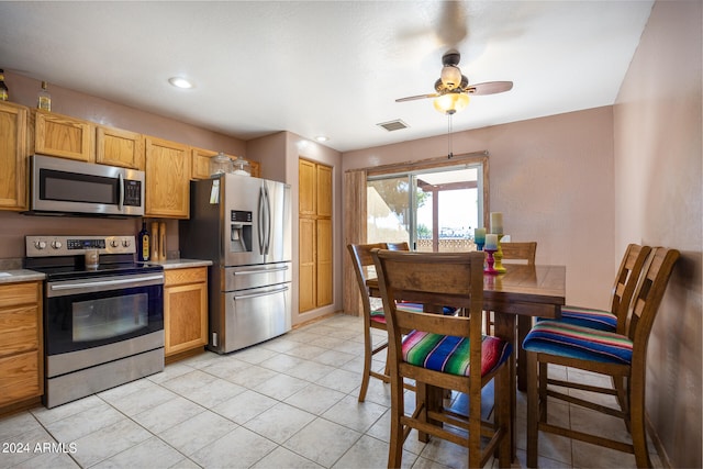 kitchen featuring stainless steel appliances, ceiling fan, and light tile patterned floors