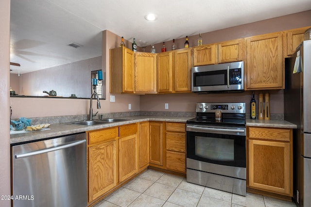 kitchen featuring ceiling fan, light tile patterned flooring, stainless steel appliances, and sink