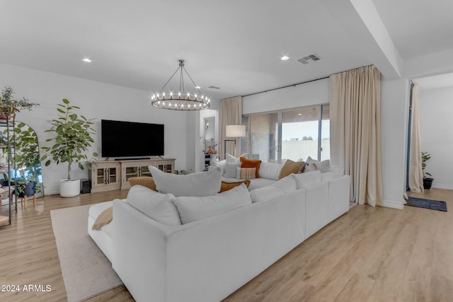 living area featuring recessed lighting, visible vents, light wood-style flooring, and an inviting chandelier