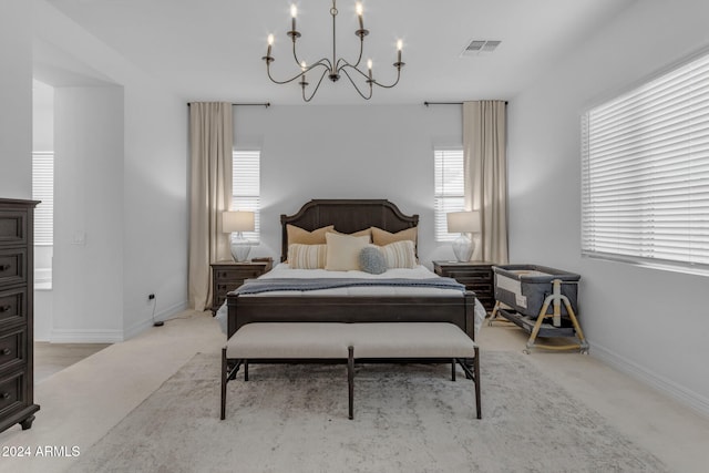 bedroom with a chandelier, visible vents, light carpet, and baseboards