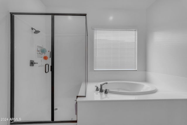 full bathroom with a shower stall and a garden tub