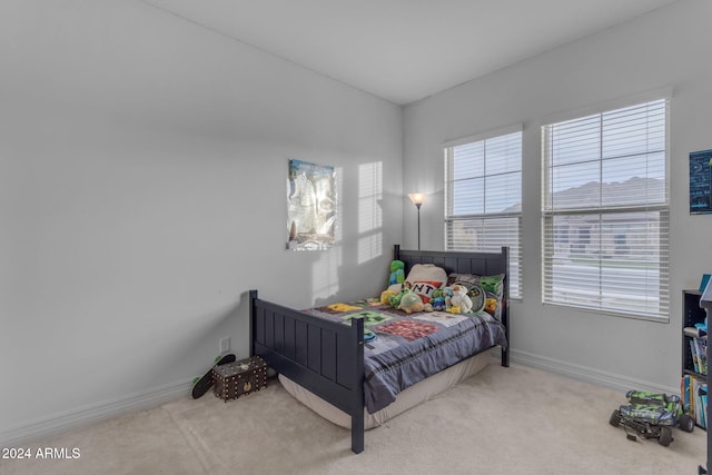 carpeted bedroom featuring baseboards