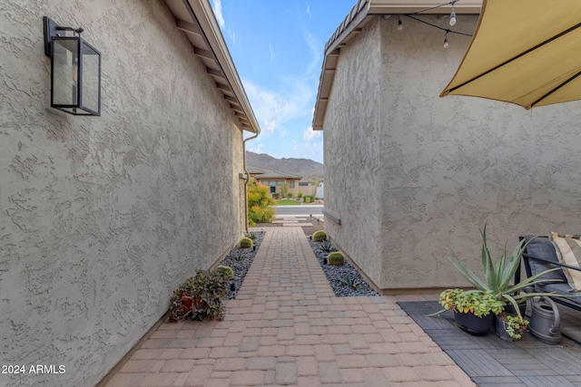 view of side of home featuring stucco siding and a patio