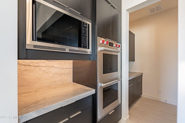 kitchen featuring appliances with stainless steel finishes and light hardwood / wood-style floors