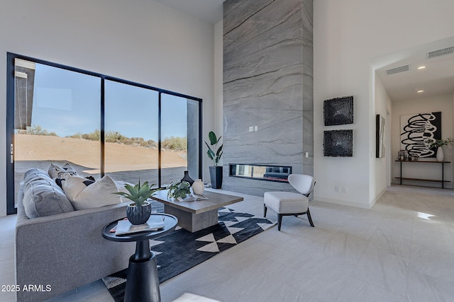 living room featuring a high ceiling and a premium fireplace