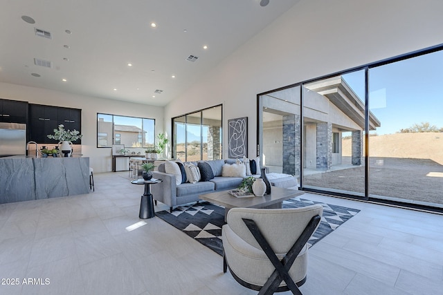 living room with sink and high vaulted ceiling