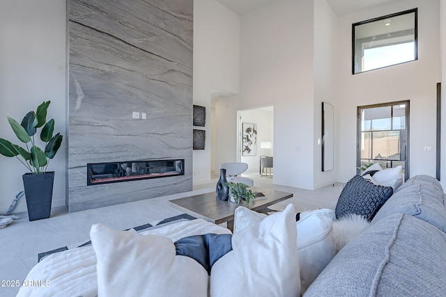 living room featuring a towering ceiling and a fireplace