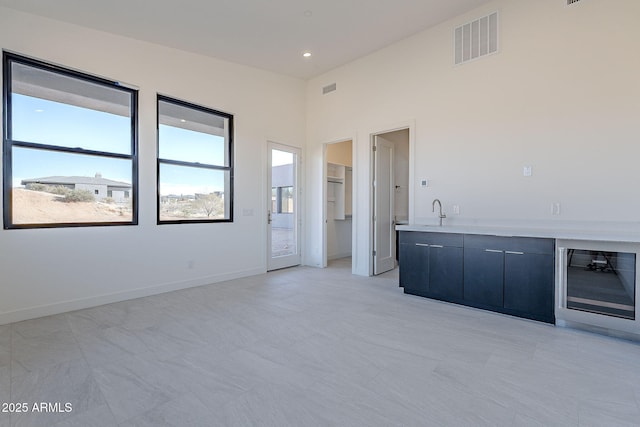 spare room featuring sink and beverage cooler