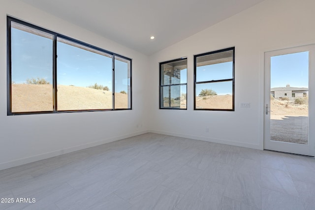 tiled empty room with lofted ceiling