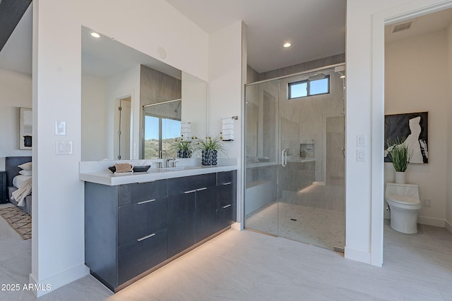 bathroom with a wealth of natural light, a shower with shower door, and toilet