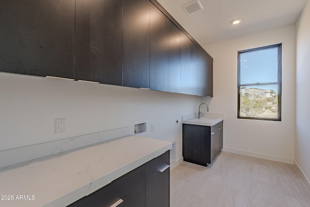 laundry area featuring cabinets, hookup for a washing machine, and sink