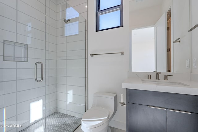 bathroom featuring vanity, toilet, and a shower with door