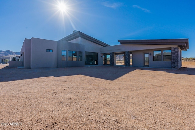 back of property with a mountain view