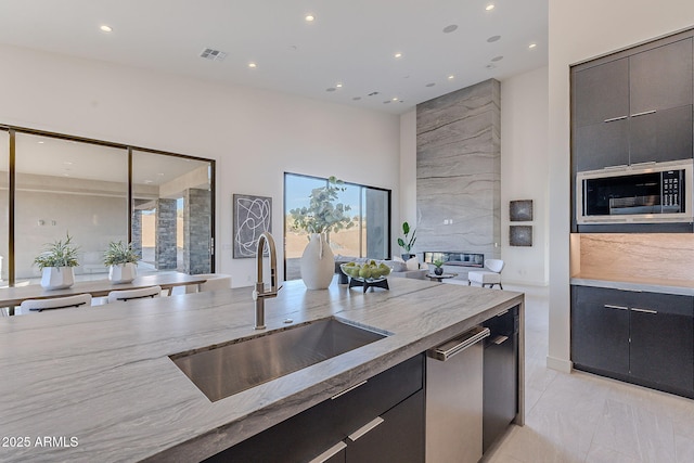 kitchen with built in microwave, sink, and dishwasher