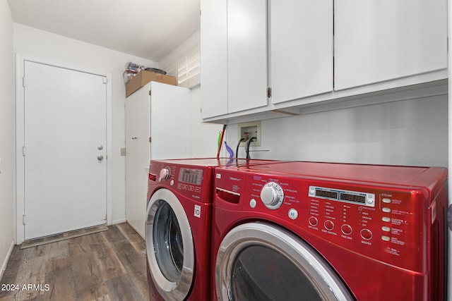 laundry room featuring dark hardwood / wood-style flooring, separate washer and dryer, and cabinets