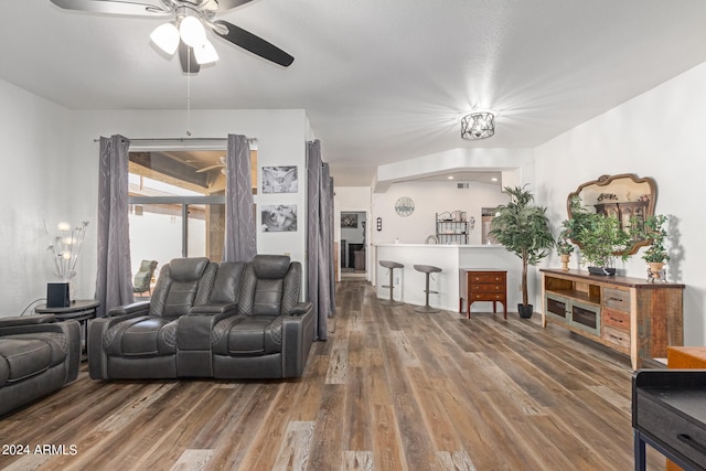 living room featuring ceiling fan and hardwood / wood-style flooring