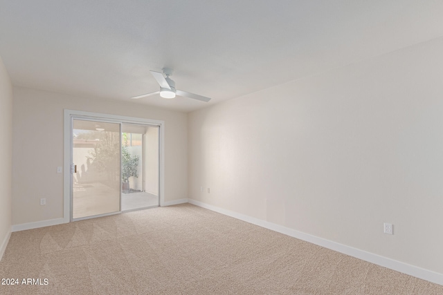 carpeted spare room with ceiling fan