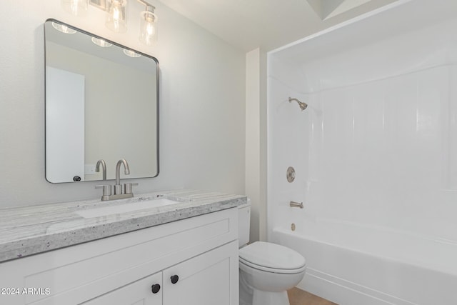 full bathroom with vanity, toilet, and  shower combination