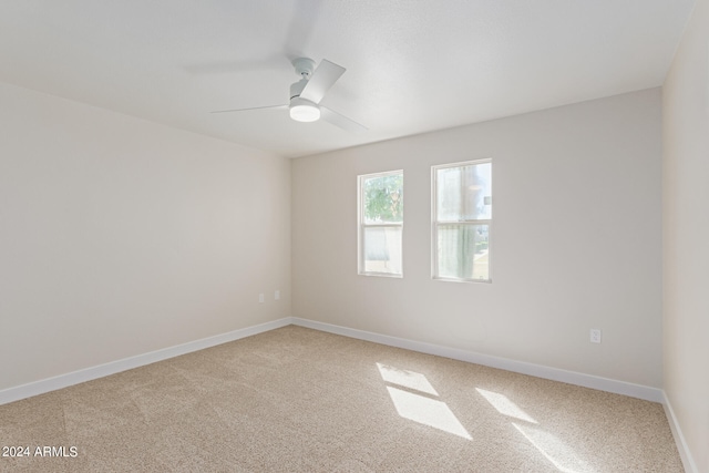 empty room featuring carpet flooring and ceiling fan