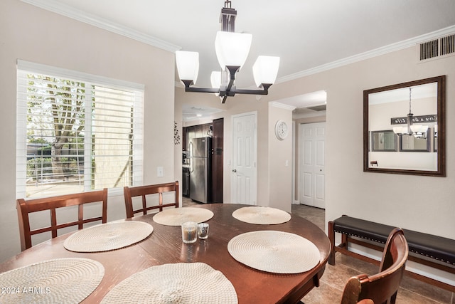 tiled dining space featuring ornamental molding and a chandelier