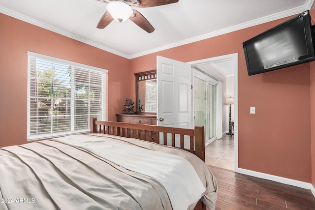 bedroom featuring dark hardwood / wood-style floors, ceiling fan, and crown molding