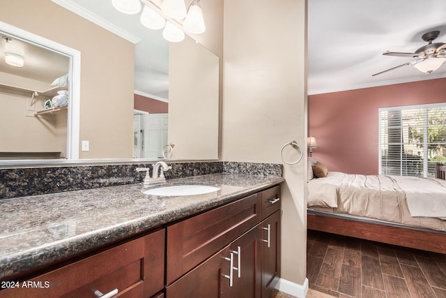 bathroom featuring hardwood / wood-style floors, ceiling fan, crown molding, and vanity