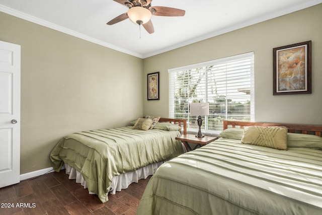 bedroom featuring dark hardwood / wood-style floors, ceiling fan, and crown molding