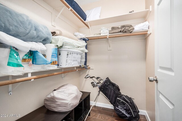 spacious closet with dark hardwood / wood-style flooring