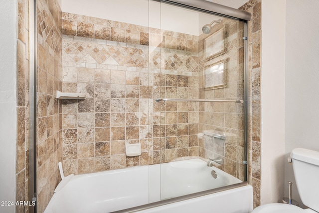 bathroom featuring shower / bath combination with glass door and toilet