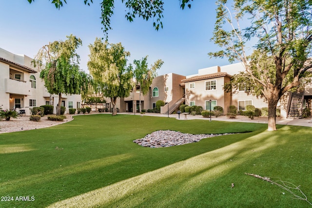 view of home's community featuring a lawn