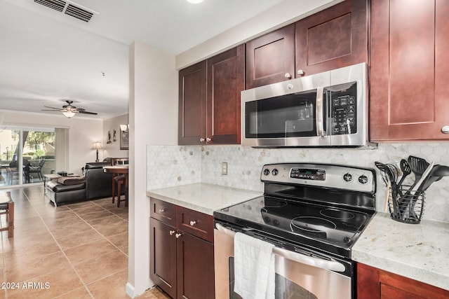 kitchen featuring decorative backsplash, appliances with stainless steel finishes, light stone countertops, and ceiling fan