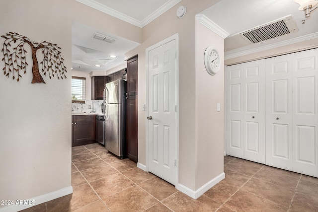 corridor featuring crown molding and light tile patterned flooring