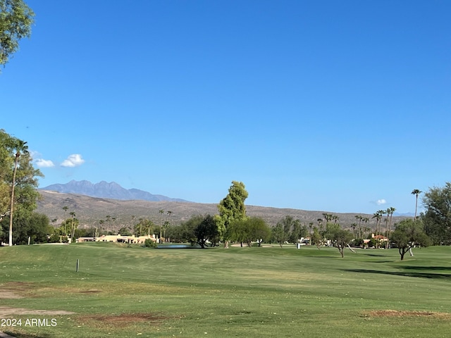 view of property's community featuring a mountain view and a yard