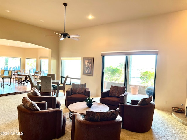 carpeted living room with a healthy amount of sunlight and ceiling fan