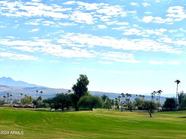 view of community with a lawn and a mountain view