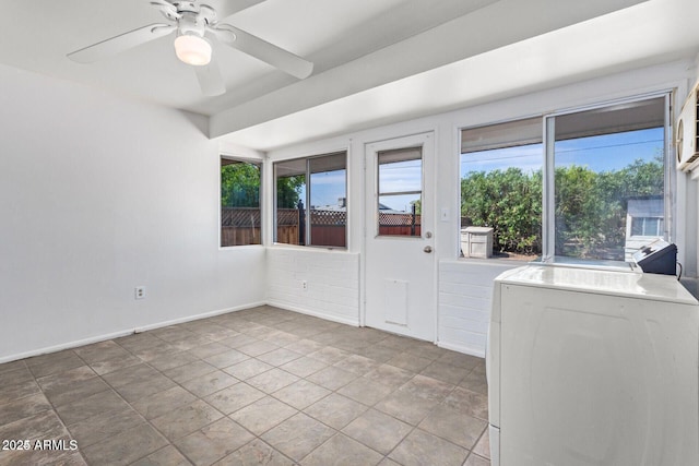 interior space featuring washer / dryer, ceiling fan, and baseboards