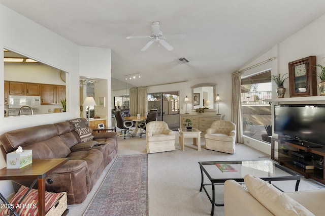 carpeted living room featuring ceiling fan and vaulted ceiling