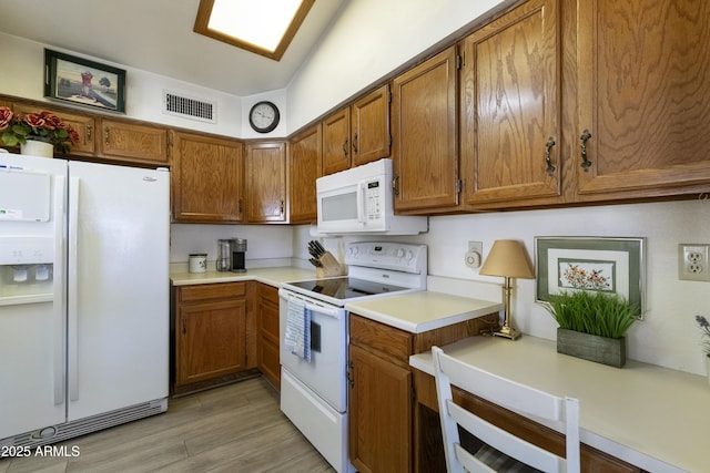 kitchen featuring white appliances and light wood-type flooring